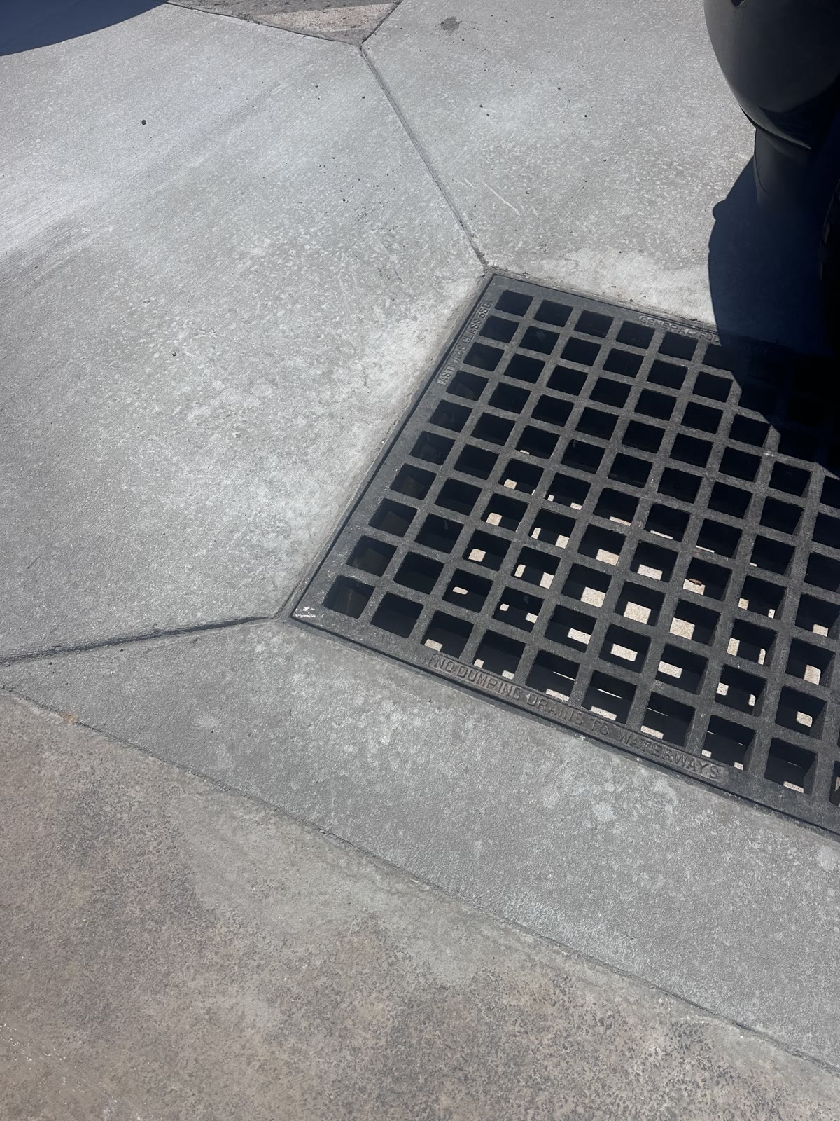 New commercial catch basin surrounded by finished concrete