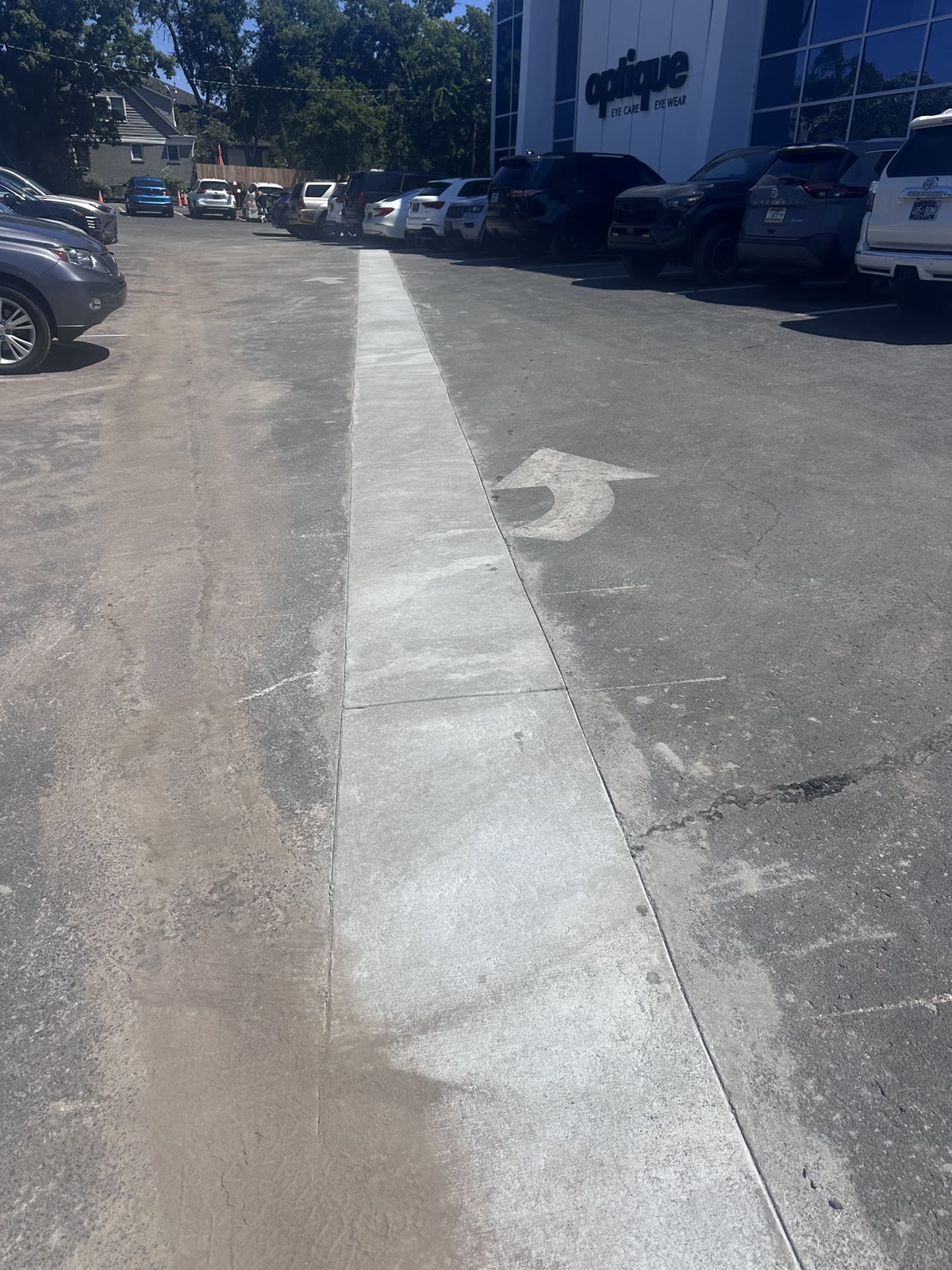 Long concrete drainage retrofit through a busy commercial parking lot