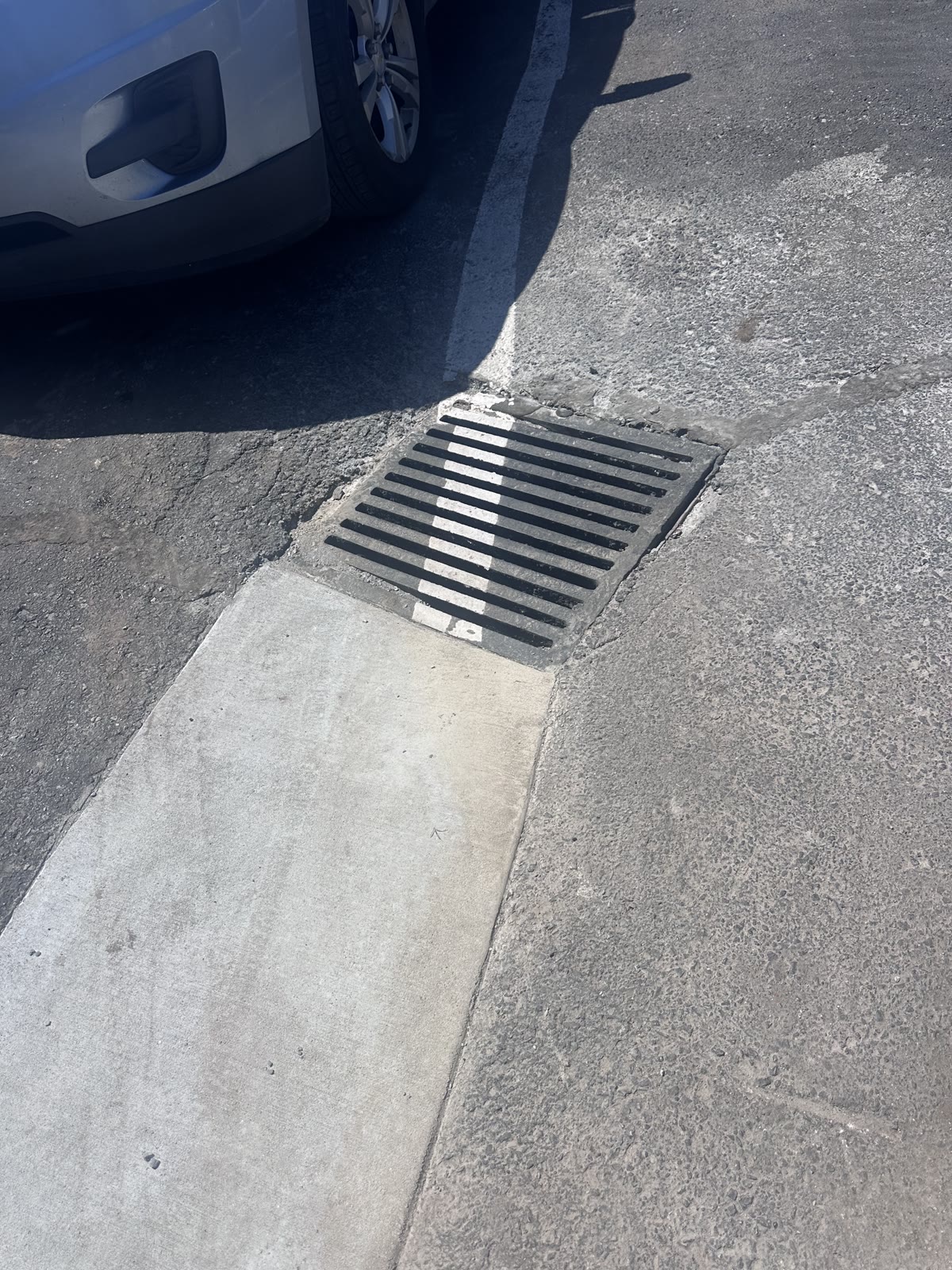 Completed trench drain transition between asphalt and concrete