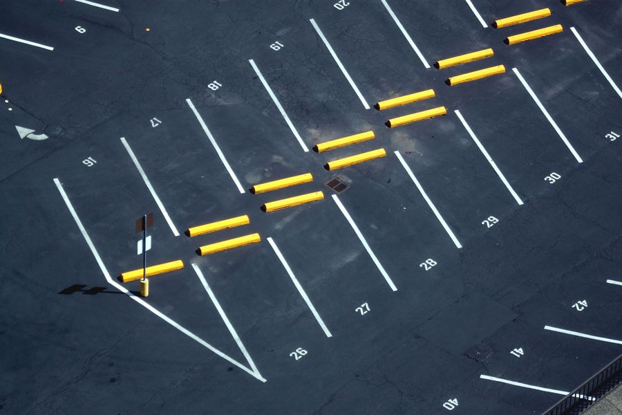 Freshly painted white stall lines on a commercial asphalt parking lot